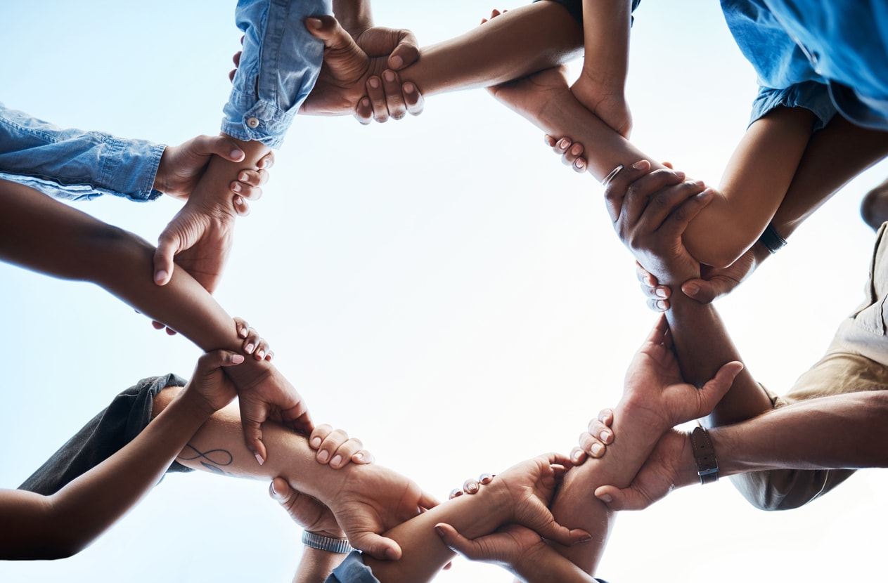 People circling hands in a show of unity